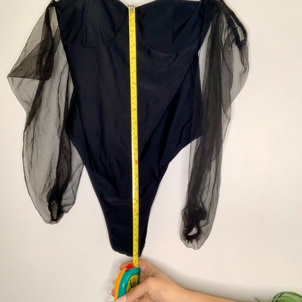 Black, puffy, sheer on arms one piece bodysuit.